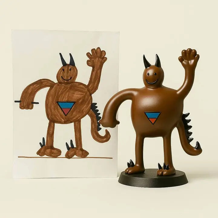 OstanesKids custom brown monster figurine from child’s drawing with horns, tail, and waving hand.