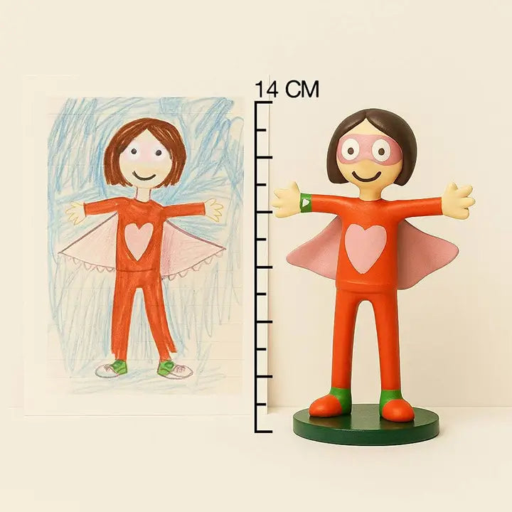 OstanesKids superhero figurine custom-made from child’s drawing with red suit and pink cape.