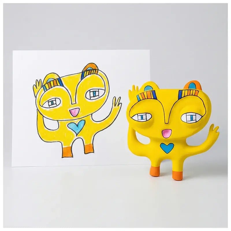A Yellow Creature figurine by Ostaneskids recreated from a child’s drawing with colorful painted details