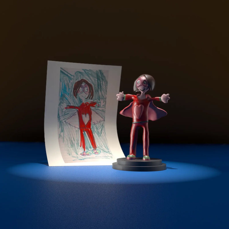 Superhero mum figurine inspired by a child’s crayon drawing, with a heart on the chest and cape spread open.