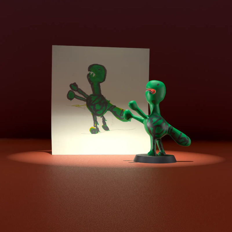 Green Godzilla figurine with red mouth and four arms, inspired by a child’s drawing of a fantasy monster.