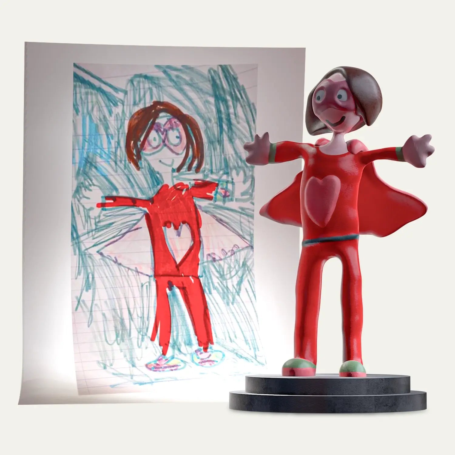 A childhood drawing of a superhero mum stands beside its matching 3D customised figurine, slowly rotating on a turntable to reveal every handcrafted detail of this voice-ready personalised keepsake.